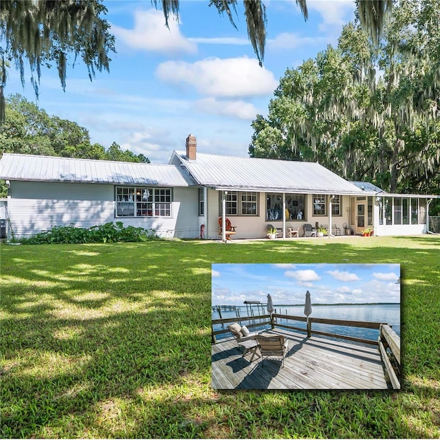 back of house featuring a yard and a wooden deck