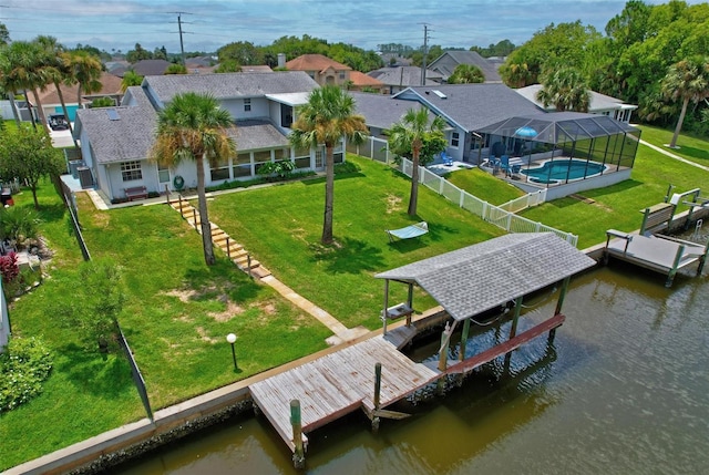 exterior space with a yard, a water view, and a lanai