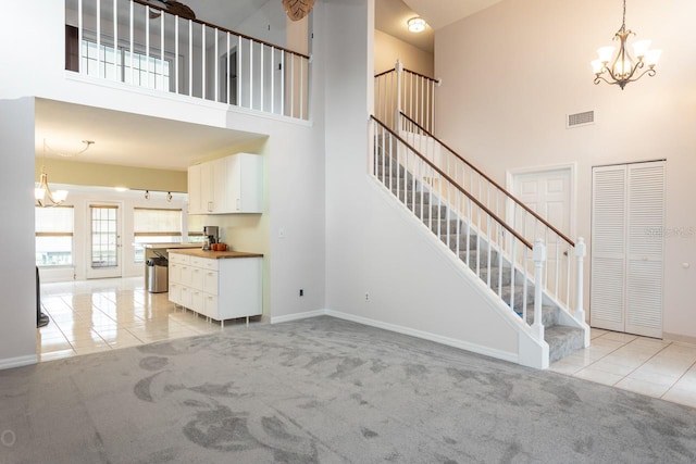 stairway with carpet and a high ceiling