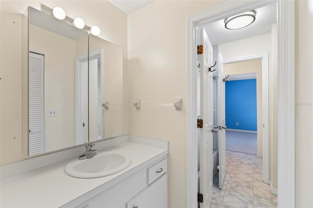 bathroom featuring vanity, a textured ceiling, and tile patterned floors