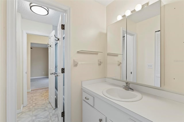 bathroom featuring a textured ceiling and vanity