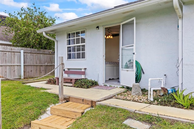 entrance to property featuring a lawn