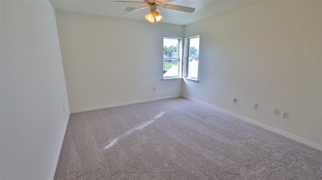 spare room featuring carpet flooring, ceiling fan, and a textured ceiling