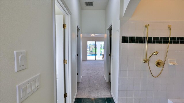 corridor with dark tile patterned flooring