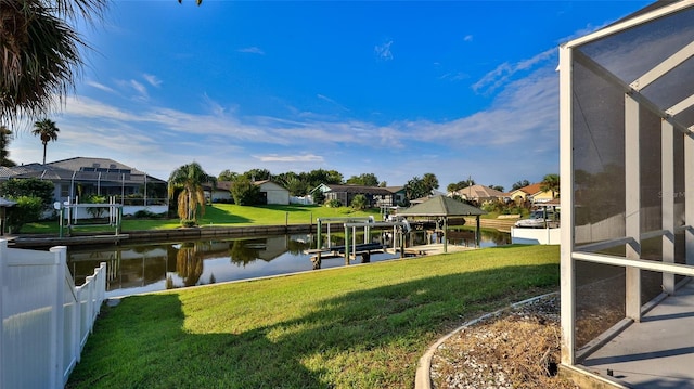 dock area with a water view and a lawn