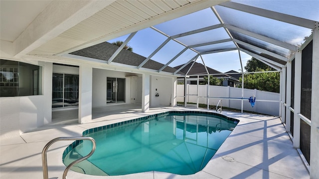 view of pool with a patio, ceiling fan, and a lanai