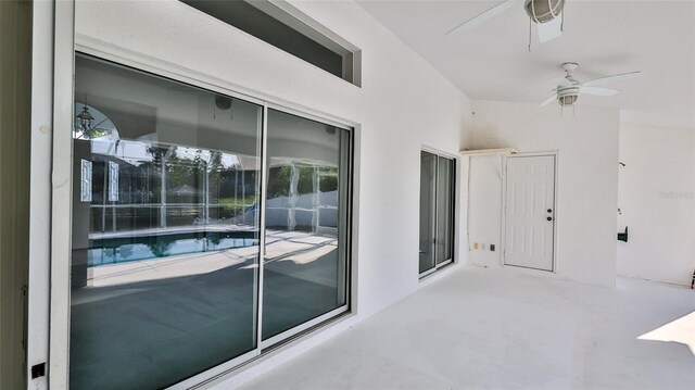 interior space with ceiling fan