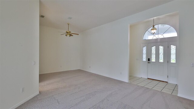 entrance foyer with light colored carpet, ceiling fan, and lofted ceiling