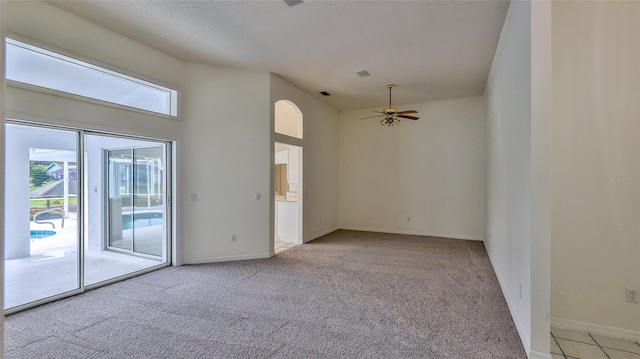 spare room featuring light colored carpet and ceiling fan