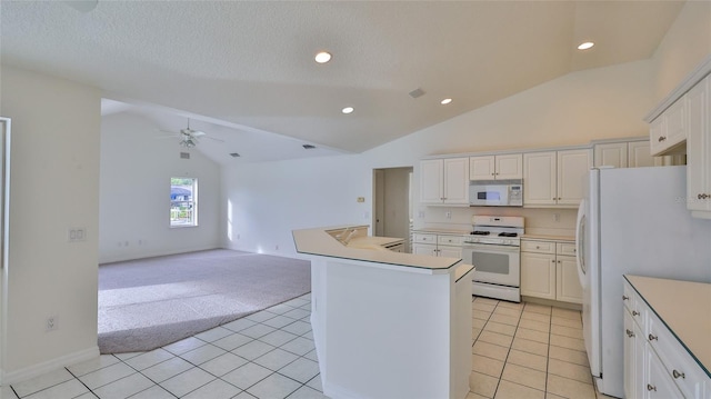 kitchen featuring white cabinets, white appliances, a kitchen island, and lofted ceiling