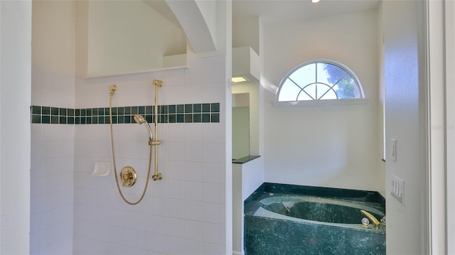 bathroom with shower with separate bathtub