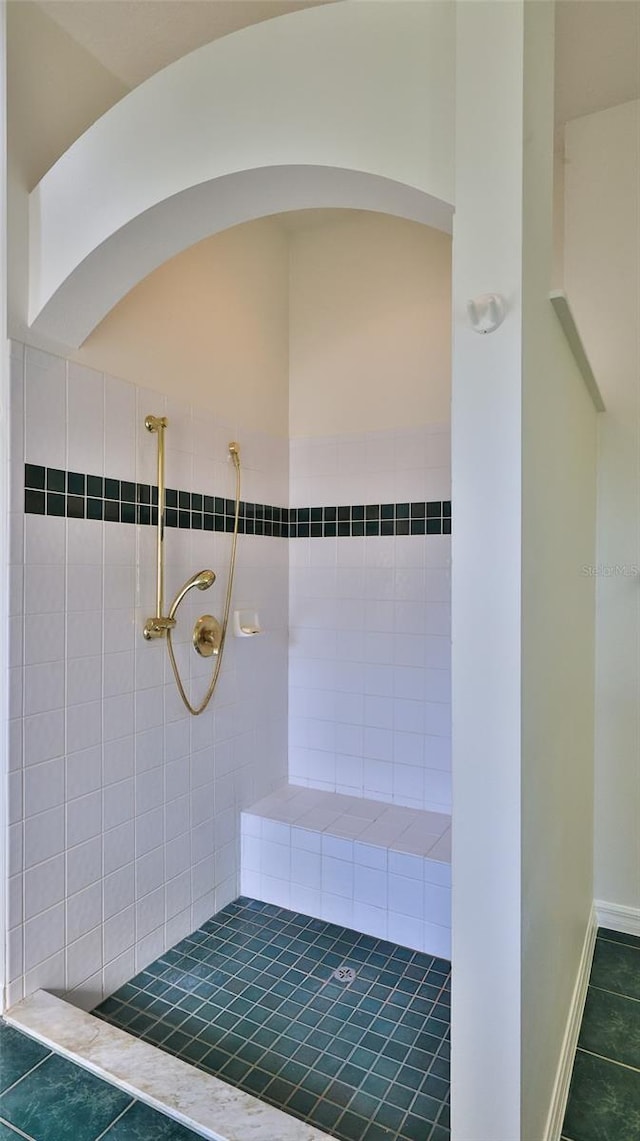 bathroom with tile patterned flooring and walk in shower