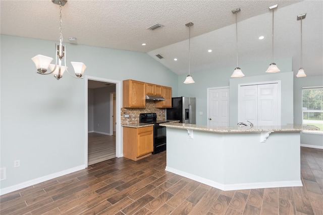 kitchen featuring stainless steel fridge, pendant lighting, and electric range