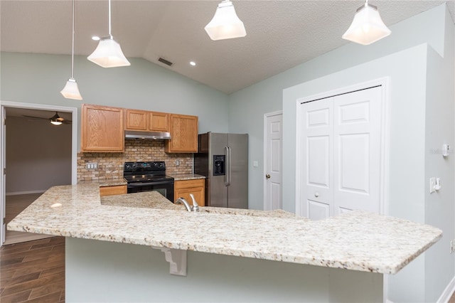 kitchen with pendant lighting, black electric range, stainless steel refrigerator with ice dispenser, visible vents, and under cabinet range hood