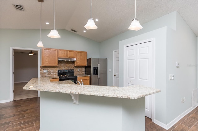 kitchen featuring pendant lighting, stainless steel fridge, visible vents, and black electric range oven