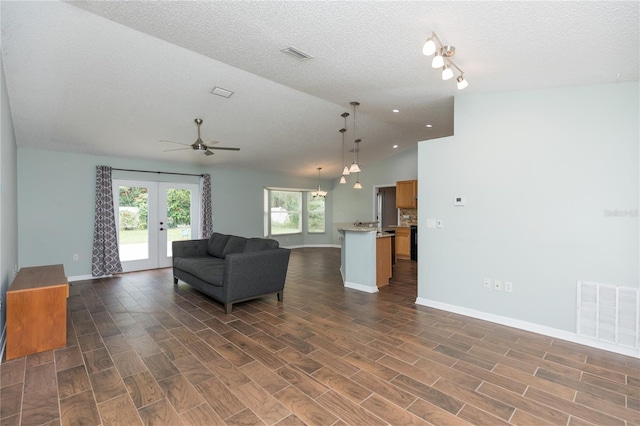 unfurnished living room featuring dark wood-style floors, french doors, lofted ceiling, and visible vents