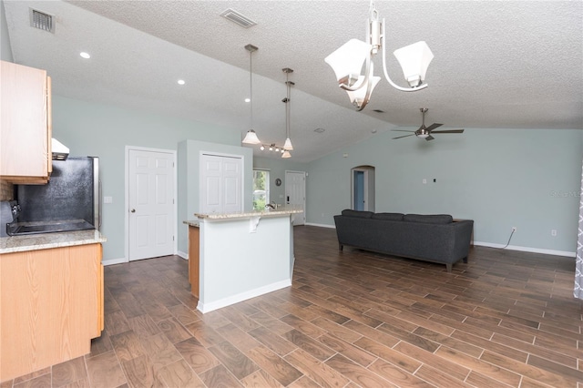 kitchen featuring visible vents, open floor plan, freestanding refrigerator, dark wood finished floors, and decorative light fixtures