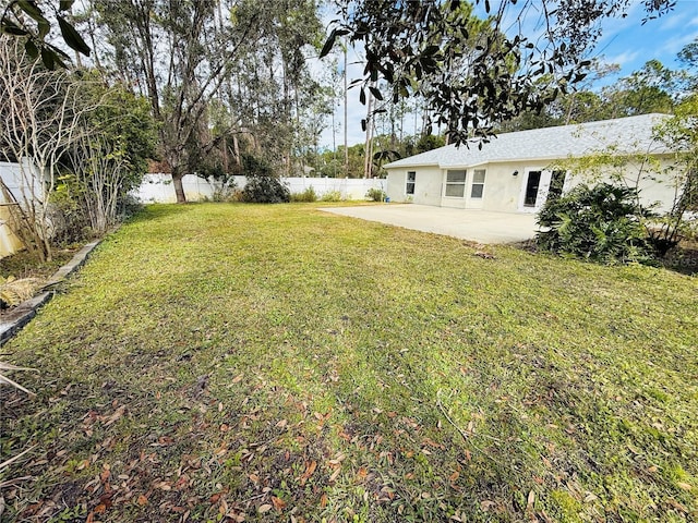 view of yard with a patio area and a fenced backyard