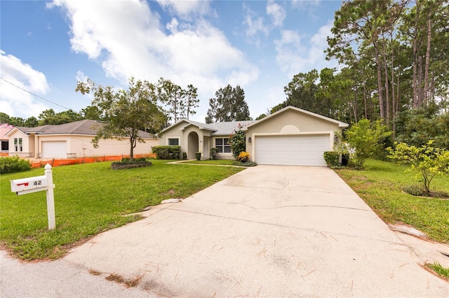 ranch-style home featuring a front yard, driveway, an attached garage, and stucco siding