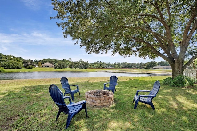 view of yard featuring a fire pit and a water view