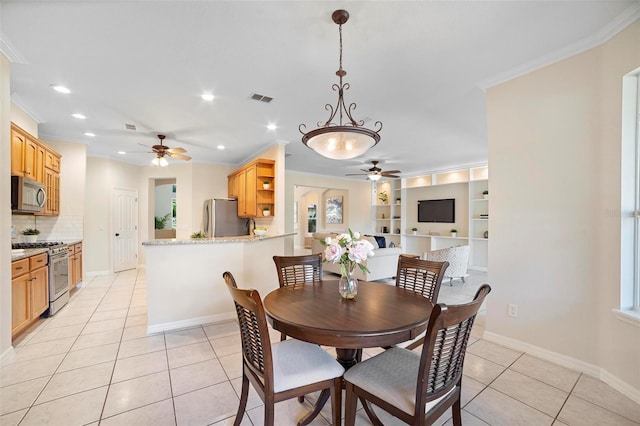 dining space with light tile patterned floors and ornamental molding