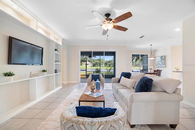 living room with built in shelves, crown molding, light tile patterned flooring, and ceiling fan