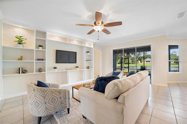 living room featuring ceiling fan, light tile patterned floors, and ornamental molding