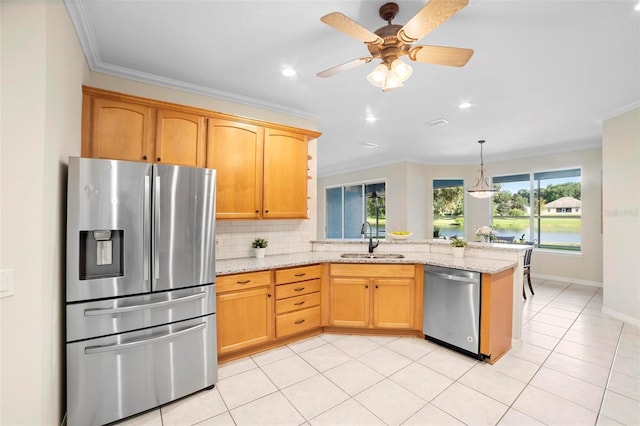 kitchen with light stone counters, ornamental molding, and appliances with stainless steel finishes