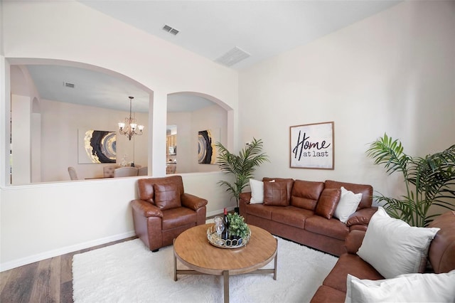 living room with a chandelier and hardwood / wood-style flooring