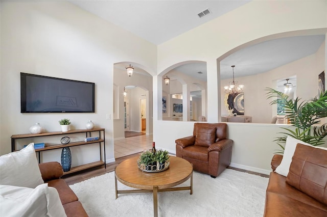 living room with a notable chandelier and light hardwood / wood-style flooring