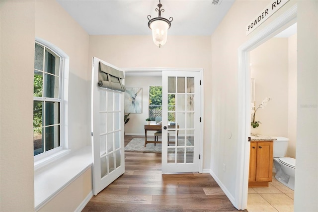 doorway featuring wood-type flooring and french doors