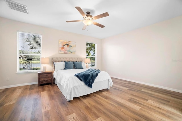 bedroom with ceiling fan and hardwood / wood-style flooring