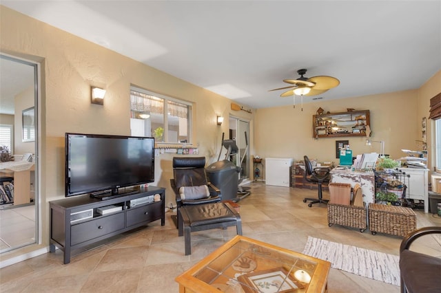 living room featuring ceiling fan and light tile patterned flooring