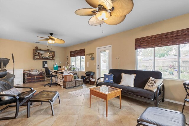 living room with ceiling fan and light tile patterned floors