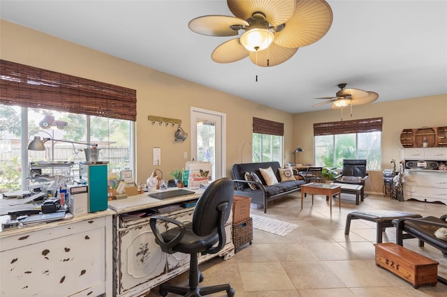 home office featuring light tile patterned floors and ceiling fan