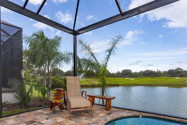 view of patio / terrace featuring a lanai and a water view