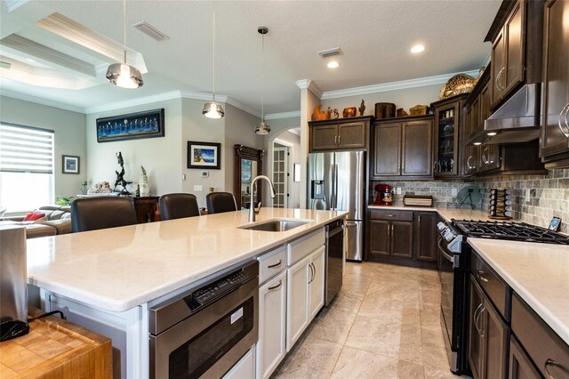 kitchen featuring stainless steel appliances, decorative backsplash, sink, crown molding, and wall chimney range hood