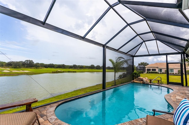 outdoor pool with a lawn, a lanai, a water view, and a patio