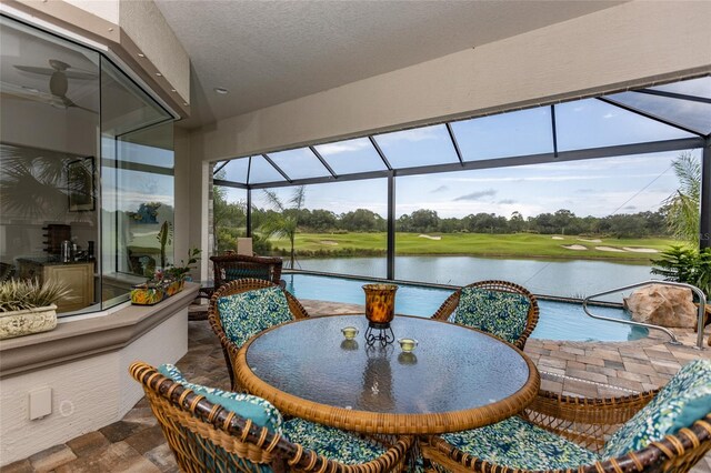 sunroom / solarium with a water view