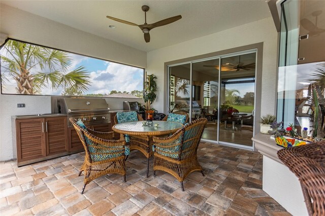 exterior space featuring exterior kitchen, ceiling fan, and a grill