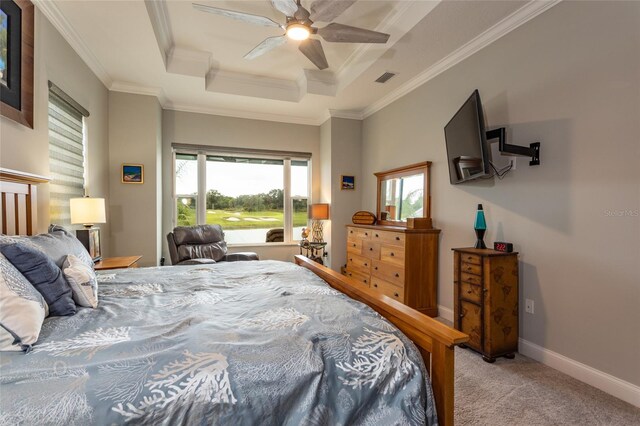 bedroom with ceiling fan, ornamental molding, light carpet, and a tray ceiling