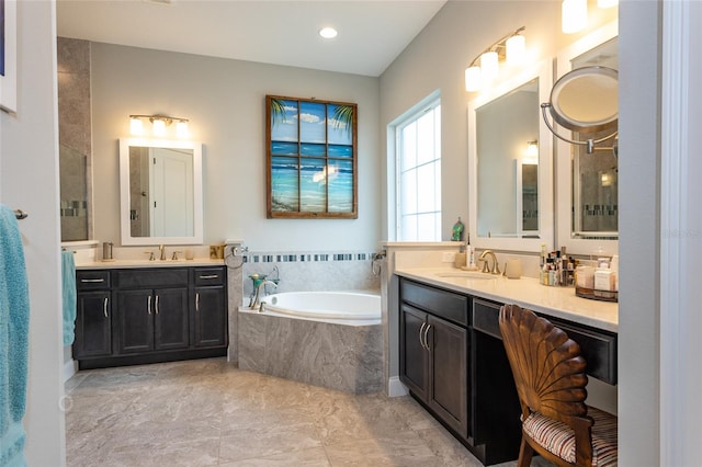 bathroom featuring a shower, a sink, two vanities, and a bath