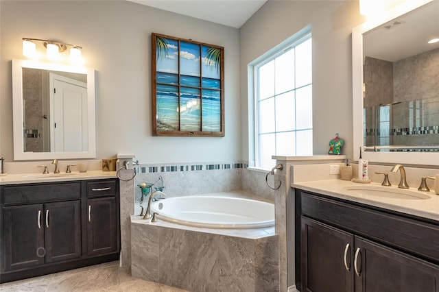 full bath with a garden tub, a sink, a stall shower, and two vanities