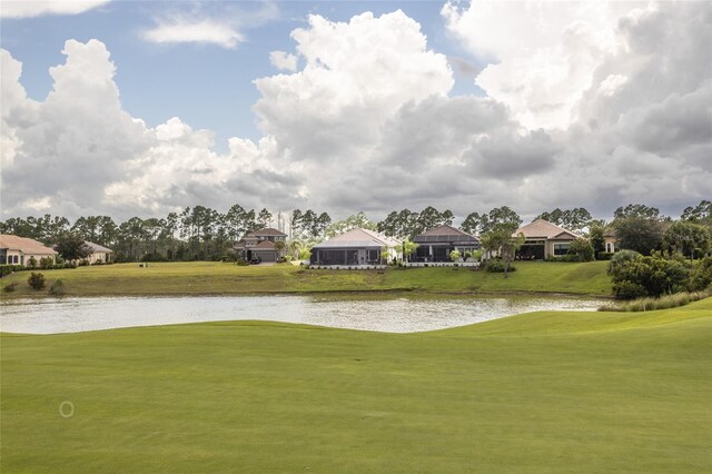 view of home's community featuring a water view and a yard