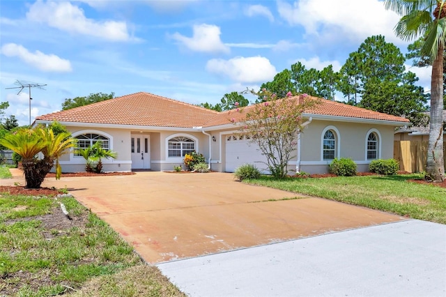 mediterranean / spanish house with a garage