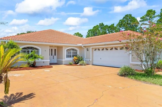 mediterranean / spanish home featuring a garage