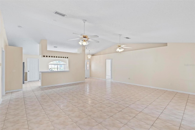 tiled spare room with ceiling fan and high vaulted ceiling