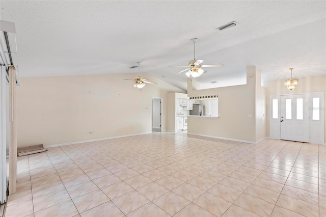 unfurnished living room featuring ceiling fan with notable chandelier, lofted ceiling, and light tile patterned flooring