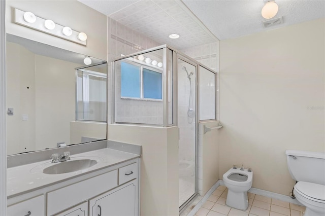 bathroom with a bidet, tile patterned floors, vanity, toilet, and walk in shower