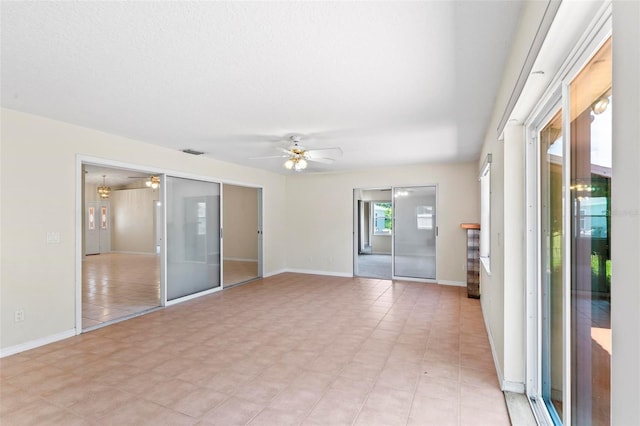 spare room featuring ceiling fan and light tile patterned floors